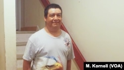 Shown standing at the entrance to his apartment, Guillermo Peralta was arrested by immigration agents on his way to work last February.