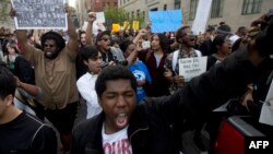 A demonstrator shouts during a protest in downtown Baltimore, Maryland, on April 29, 2015, seeking justice for an African-American man who died of severe spinal injuries sustained in police custody.