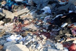FILE - Blood stains are seen at a detention center for mainly African migrants that was hit by an airstrike in the Tajoura suburb of Tripoli, Libya, July 3, 2019.