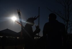 A member of the Kayapo tribe carries bows and arrows at a protest camp in Brasilia, Brazil on Aug. 23, 2021.