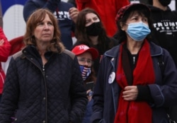 Women listen to then-U.S. President Donald Trump speak at a rally in Allentown, Pennsylvania, October 26, 2020.