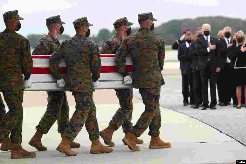U.S. President Joe Biden salutes during the dignified transfer of the remains of U.S. Military service members who were killed by a suicide bombing at the Hamid Karzai International Airport, at Dover Air Force Base in Dover, Delaware, U.S., August 29, 202