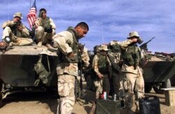 FILE - U.S. Marines are seen at a forward base in southern Afghanistan, Nov. 30, 2001.