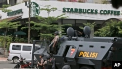 A police armored vehicle is parked outside a Starbucks cafe after an explosion in Jakarta, Indonesia, Jan. 14, 2016. 