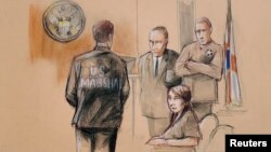 FILE - Yujing Zhang, charged with bluffing her way into President Donald Trump's Florida resort, is seated upon arrival with U.S. Marshals, awaiting the start of her hearing, at the U.S. federal court, in this courtroom sketch, in West Palm Beach, Florida