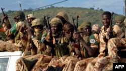 FILE - Chadian soldiers sit on a pickup truck as they leave Bangui on April 4, 2014, escorted by African-led International Support Mission to the Central African Republic (MISCA) forces (not pictured). 