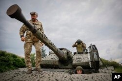 Ukrainian soldiers on a Swedish CV90 infantry fighting vehicle at their positions near Bakhmut, Donetsk region, Ukraine, Sunday, June 25, 2023.