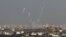 Trails of smoke are seen after the launch of rockets from the northern Gaza strip towards Israel, November 11, 2012. 