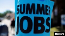 A sign advertising "Summer Jobs" hangs on a lamp post in Somerville, Massachusetts, U.S., June 15, 2016. 
