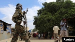 FILE - A Somali soldier patrols a street following a bombing in Afgoye, Somalia, Oct. 19, 2016.