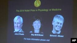 Images of the winners of the 2014 Nobel Prize for Medicine, U.S.-British scientist John O'Keefe and Norwegian husband and wife Edvard Moser and May-Britt Moser are projected on a screen during the announcement in Stockholm Monday Oct. 6, 2014.