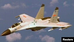 FILE - A U.S. military official says two Chinese J-11 fighters, like one pictured here, flew out to intercept a U.S. EP-3 Aries aircraft, coming so close that they forced the pilot to descend a couple hundred feet.