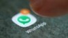 FILE - The WhatsApp app logo is seen on a smartphone in this picture illustration. 