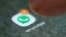 FILE - The WhatsApp app logo is seen on a smartphone in this picture illustration. 