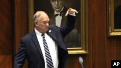 Arizona Republican state Rep. Don Shooter drops his mic after voting no on a resolution expelling him from the Arizona House for a pattern of sexual harassment in Phoenix, Arizona, Feb. 1, 2018.