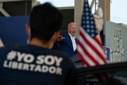 Democratic presidential candidate former Vice President Joe Biden speaks at Miramar Regional Park in Miramar, Fla., Tuesday Oct. 13, 2020, as supporters watch from their cars.