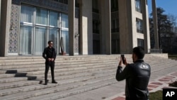 Men take pictures while visiting Niavaran Palace, now a museum, that was the primary and last residence of late Shah Mohammad Reza Pahlavi and his family prior to leaving Iran for exile during the 1979 Islamic Revolution.
