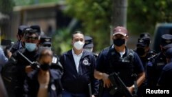 FILE PHOTO: Attorney General Rodolfo Delgado arrives at a news conference at the site where authorities are excavating a clandestine cemetery discovered at the house of a former police officer in Chalchuapa, El Salvador, May 21, 2021.