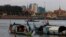 FILE PHOTO - Fishermen row their wooden boats in conjunction with rivers between the Mekong River and Tonle Sap as they catch fish during the fish harvesting season near Phnom Penh, Cambodia, Wednesday, Nov. 28, 2018. (AP Photo/Heng Sinith)