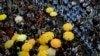 Protesters holding yellow umbrellas gather to observe a moment of silence to mark the first anniversary of "Umbrella Movement" outside the government headquarters in Hong Kong, Sept. 28, 2015. 