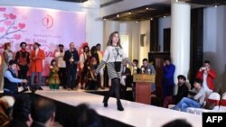 FILE - A model showcases designer clothing at a fashion show at the Serena Hotel in Kabul, Afghanistan, Feb. 14, 2020. The Taliban has denounced a similar event held last week in the Afghan capital as a demonstration of "obscene Western culture."