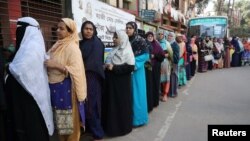Women stand in a line at a voting center to cast their ballot during the general election in Dhaka, Bangladesh, Dec. 30, 2018.