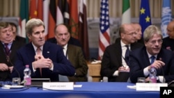 U.S. Secretary of State John Kerry, front left, and Italy's Foreign Minister Paolo Gentiloni, front right, take part in an international conference on Libya at the Ministry of Foreign Affairs in Rome, Dec. 13, 2015.