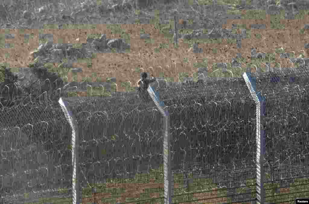 A rebel fighter in a battle with Syrian army soldiers near the Golan Heights, Sept. 1, 2014.