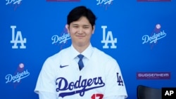 Los Angeles Dodgers' Shohei Ohtani listens to questions during a baseball news conference at Dodger Stadium on Dec. 14, 2023, in Los Angeles.