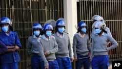 Zimbabwe police are seen outside the opposition party headquarters in Harare, June, 5, 2020.