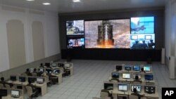 Scientists and technicians at the General Satellite Control and Command Center on the outskirts of Pyongyang watch the launch of the Unha-3 rocket from a launch site on the west coast, in the village of Tongchang-ri, North Korea, December 12, 2012.