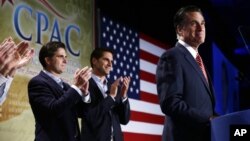 Republican presidential candidate Mitt Romney is applauded by sons Josh, center, and Tagg, left, as he speaks at a Colorado Conservative Political Action Committee (CPAC) meeting in Denver, October 4, 2012.