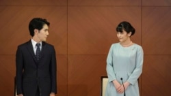 Japan's former Princess Mako, the elder daughter of Crown Prince Akishino and Crown Princess Kiko, and her husband Kei Komuro, look at each other during a press conference to announce their marriage at a hotel in Tokyo, Japan, Oct. 26, 2021. 