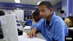 A young learner studies English on his laptop.