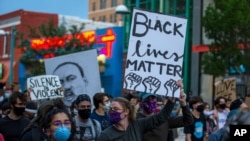 Demonstrators protest the death of George Floyd in downtown Albuquerque, N.M., May 31, 2020. 