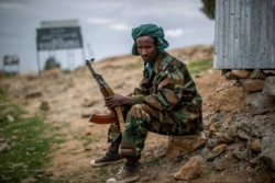 FILE - A fighter loyal to the Tigray People's Liberation Front mans a guard post on the outskirts of the town of Hawzen, then-controlled by the group but later re-taken by government forces, in the Tigray region of northern Ethiopia, May 7, 2021.