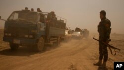 FILE - Hundreds of civilians flee villages outside Mosul a day after Iraqi Kurdish forces launched an operation east of Islamic State-held Mosul, Aug. 15, 2016.