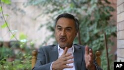 In this Tuesday, Aug 18, 2015, photo, Mohammad Daud Sultanzoy, a former lawmaker overseeing the handover of military airports for the Afghan government, speaks during an interview with the Associated Press in Kabul, Afghanistan. 