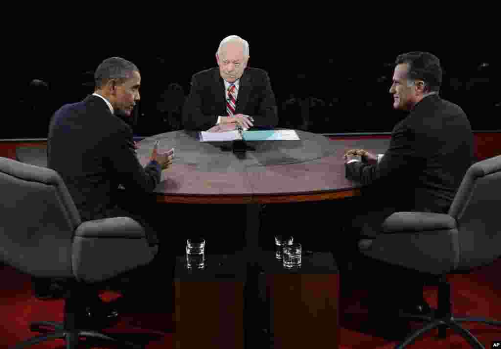 President Barack Obama speaks as Republican presidential nominee Mitt Romney and moderator Bob Schieffer listen during the third presidential debate at Lynn University, October 22, 2012, in Boca Raton, Flordia.