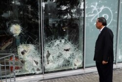 Andrew Leung, president of the Legislative Council, looks at damaged glass panels, a day after protesters broke into the council building, in Hong Kong, July 2, 2019.