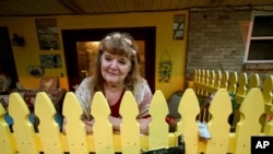 Joan Martin poses for a portrait on the front porch of her home in Picayune, Miss., Nov. 11, 2020. 
