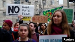 Immigration activists rally against the Trump administration's revised ban against travelers from six Muslim-majority nations, outside of the U.S. Customs and Border Protection headquarters in Washington, March 7, 2017.