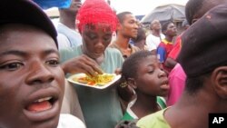 FILE - Residents of Paynesville, Liberia listen as a spokesperson for the advocacy group Crusaders for Peace educates them about the deadly ebola virus