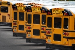 Fairfax County Public School buses are lined up at a maintenance facility in Lorton, Va., Friday, July 24, 2020.