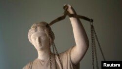 FILE - A Justice statue is pictured at a lawyer's office in Tehran, Iran, May 9, 2011.