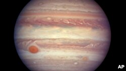 This image from NASA shows Jupiter about 668 million kilometers (415 million miles) from Earth. Jupiter is extra close and extra bright this week, and the Hubble Space Telescope took advantage of the opportunity to make this photo of the gas giant.