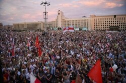 FILE - Opposition supporters protest against disputed presidential elections results at Independence Square in Minsk, Belarus, Aug. 18, 2020.