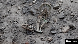 A bicycle covered with ash lies outside a house affected by the eruption of the Fuego volcano at San Miguel Los Lotes in Escuintla, Guatemala, June 6, 2018.