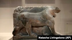 A 3D printed recreation of the ancient Lion of Mosul, which was destroyed by the Islamic State group at the Mosul Museum in Iraq, is displayed as part of the 'What Remains' exhibition at the Imperial War Museum in London, Wednesday, July 3, 2019. (AP Photo/Natasha Livingstone)