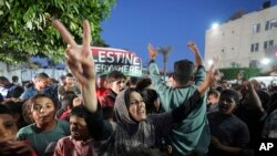 Palestinians celebrate in the streets following Hamas's announcement that it accepted a cease-fire proposal in Deir al-Balah, Gaza Strip on May 6, 2024. Despite the Hamas announcement, Israel said later it would move forward with its planned offensive on Rafah.